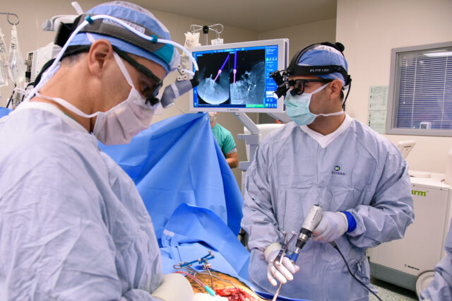 UF Health neurosurgeons operate on a patient's spine