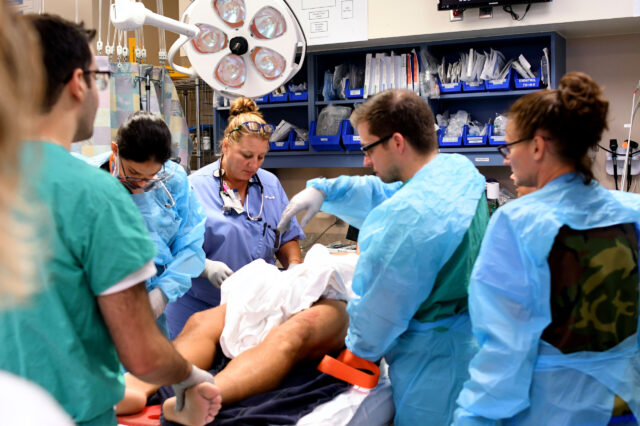 Physicians, nurses and technicians care for an injured patient in the trauma center