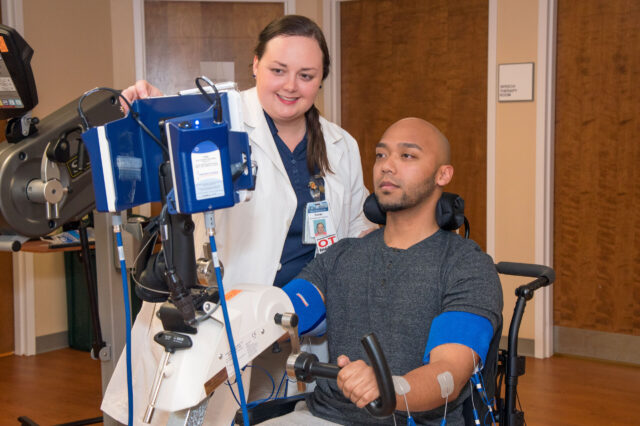 UF Health occupational therapist works with patient in wheelchair