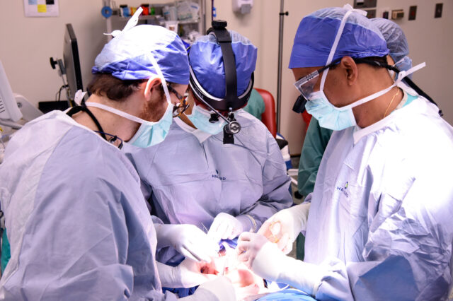 UF oral and maxillofacial surgeons operate on a patient in an operating room