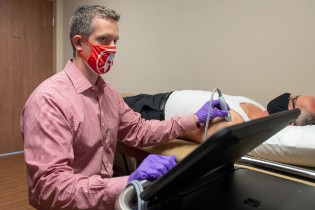 Dr. Kiel performs ultrasound on a patient's shoulder