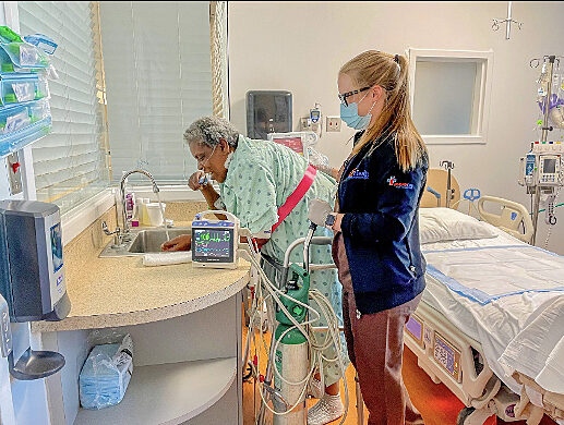 Specialist working with patient in hospital room