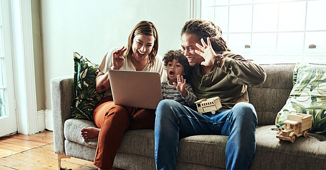 Young family playing a game on the computer together