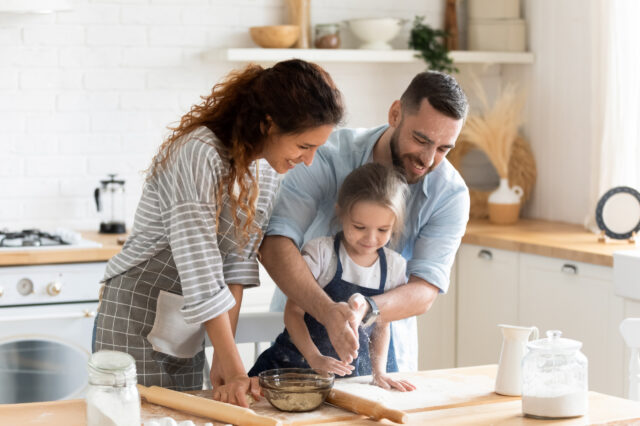 Woman man and young girl baking together