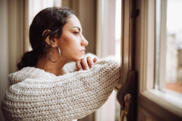 Woman looking out a window